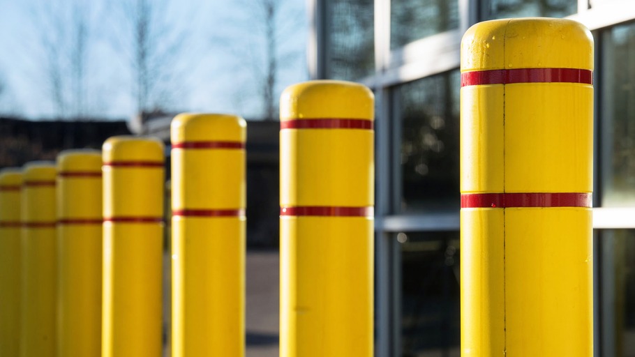 A collection of yellow plastic bollard covers