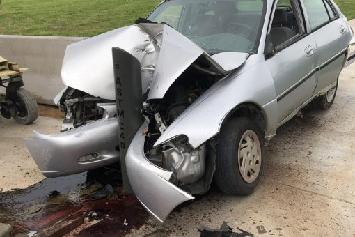Car ramming into crash-rated bollard