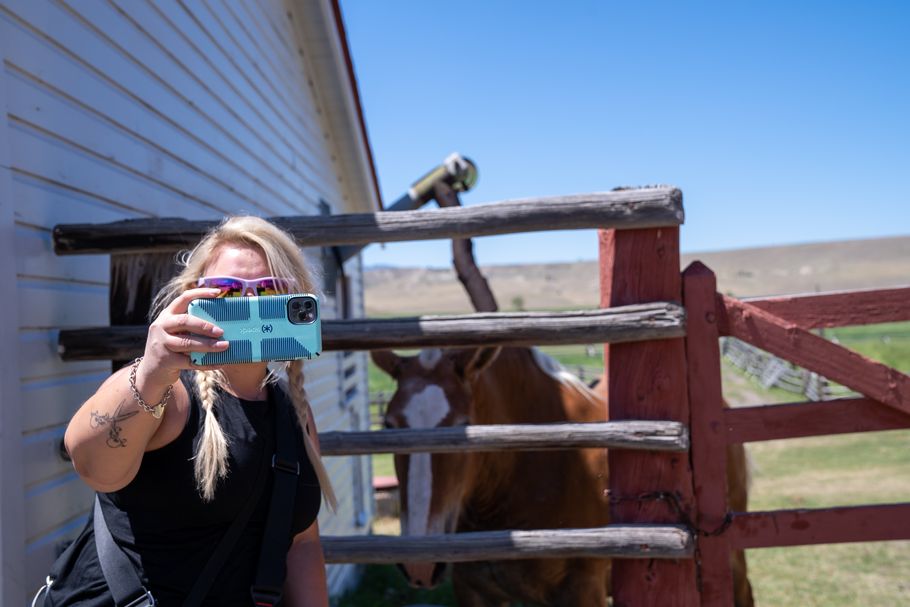 A tourist takes a selfie at a Montana ranch