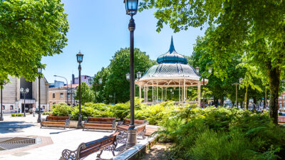 A city plaza with benches, trees, and a gazebo
