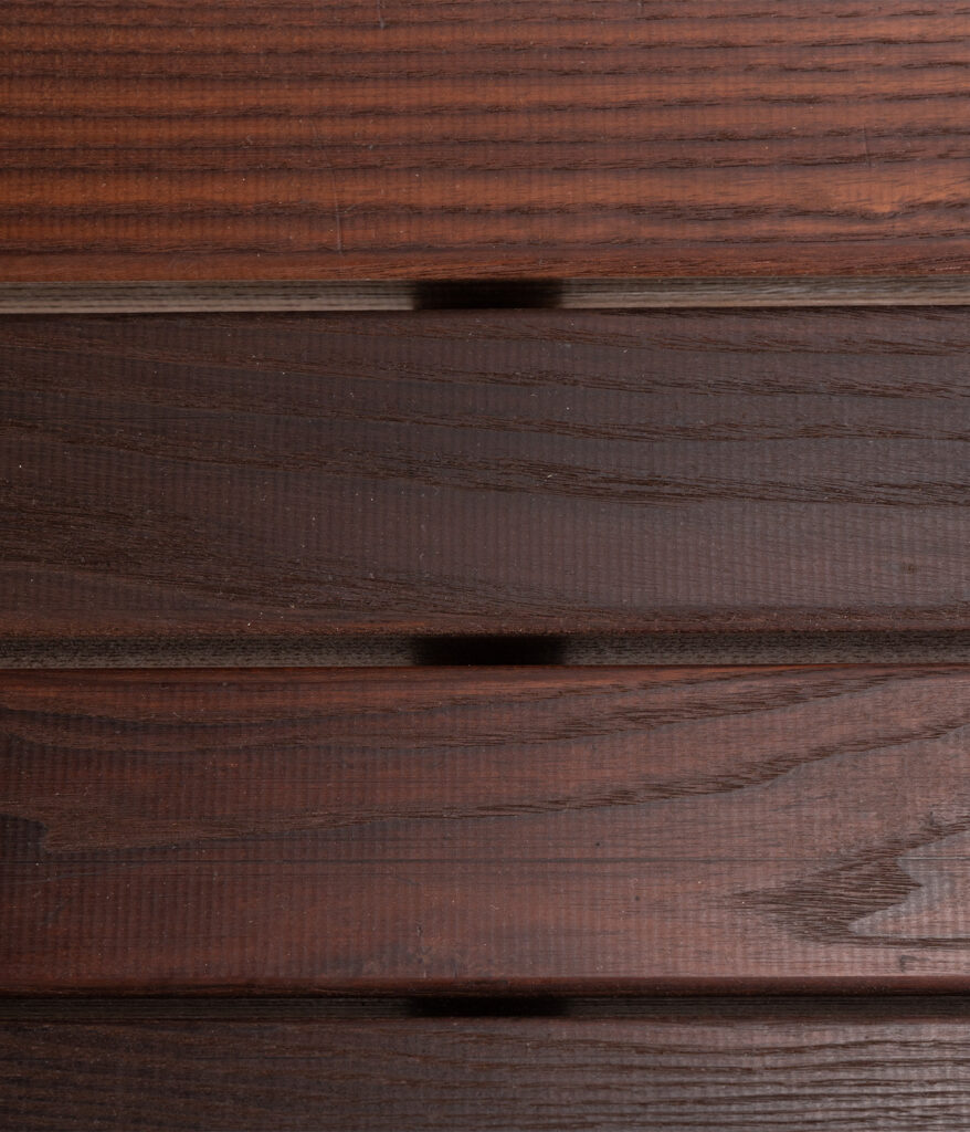 A close-up shot of the wood slats of the R-5514 World's Fair Bench, showing the wood grain detail