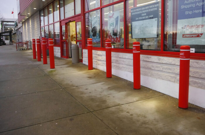 Red R-7109 plastic bollard covers at building entrance