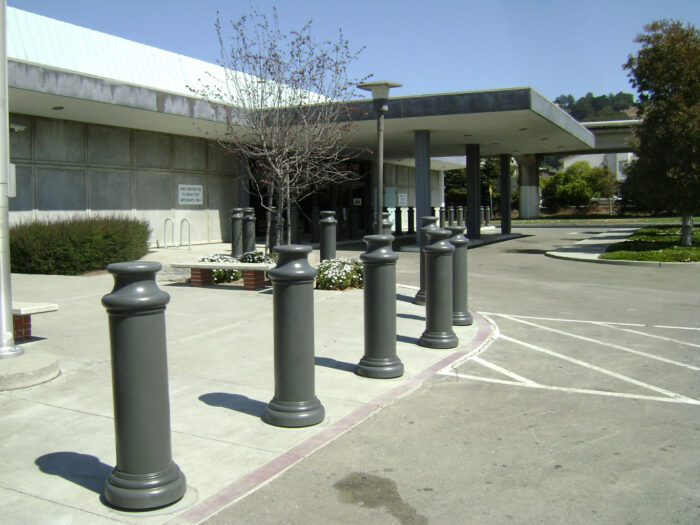 Row of R-7174 decorative plastic bollard covers at front of building