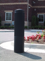 R-7176 decorative plastic bollard cover on road in front of flowers