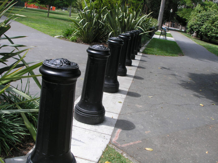 Line of R-7520 decorative bollards on top of concrete painted white