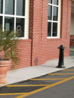 R-7538 decorative bollard stands in front of brick building