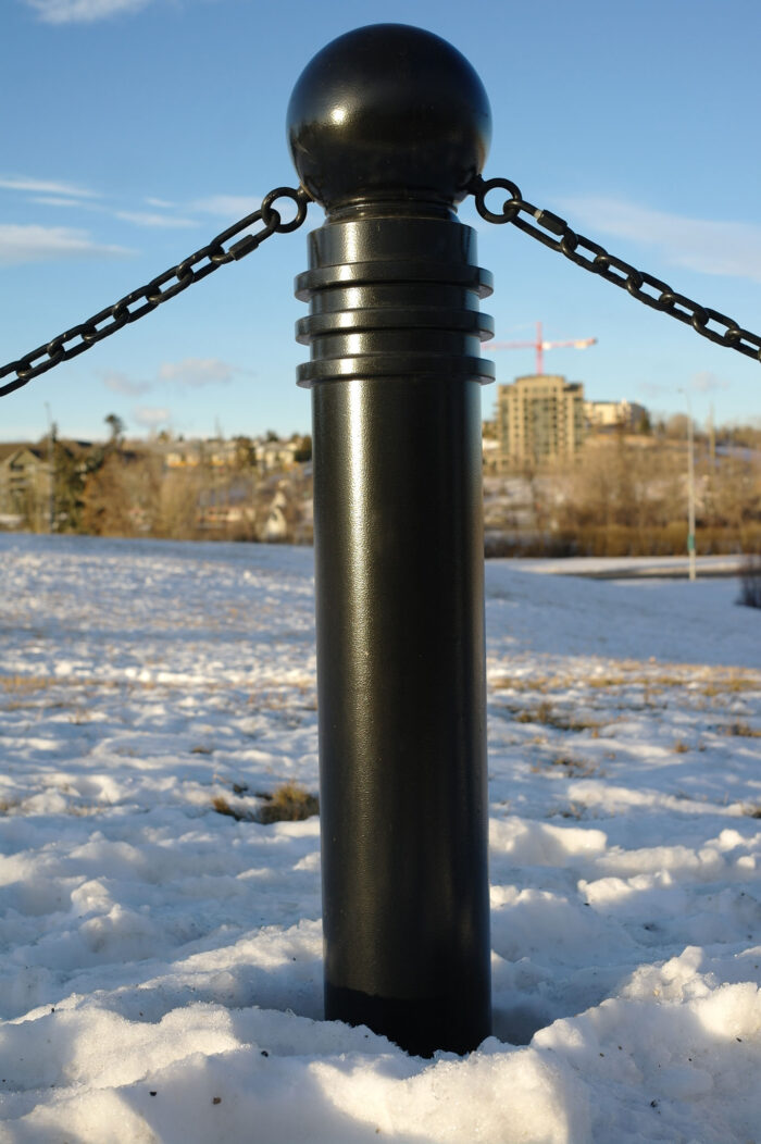 Lone R-7571 bollard with chains in snow