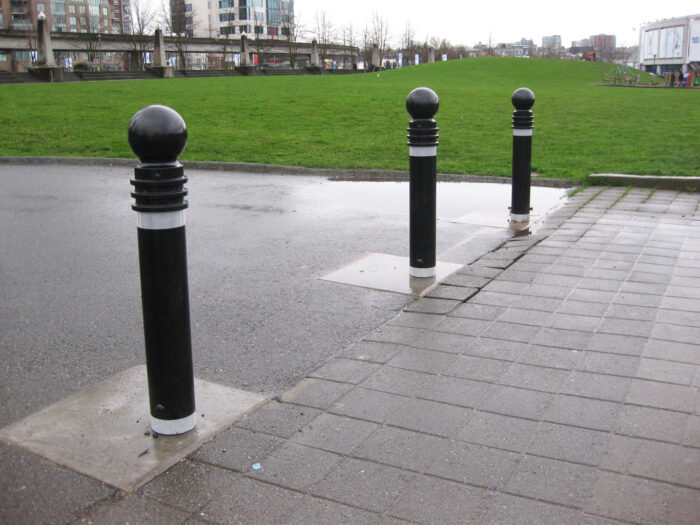 Three R-7572 decorative bollards in middle of pathway