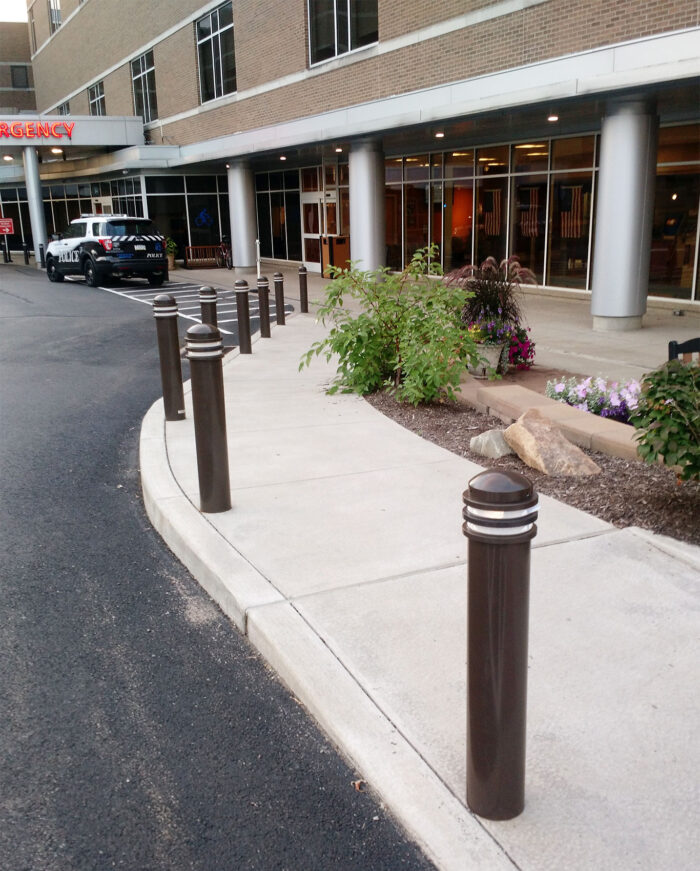 R-7576 decorative bollards on curved road in front of building
