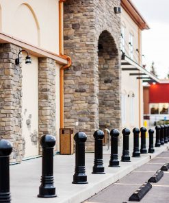 Row of R-7592 decorative bollards in front of brick building