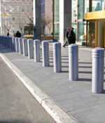 Row of silver R-7736 decorative bollards in front of building