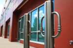 Two R-8904 stainless steel bike bollards in front of building