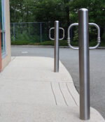 Two R-8904 stainless steel bike bollards on concrete