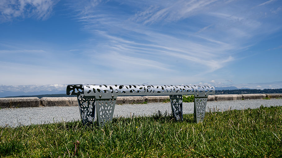 Reliance Foundry's Austin bench in a park with a mountain view