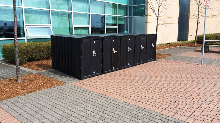 An image of four Reliance Foundry R-8285 bike lockers installed in front of an office building.