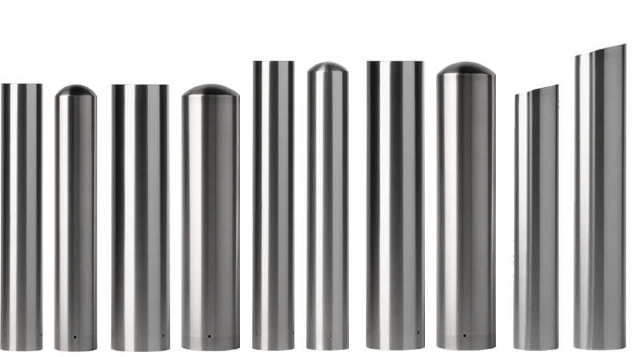 Stainless steel bollard covers in different heights and shapes are striped with light and shadow in a studio shot