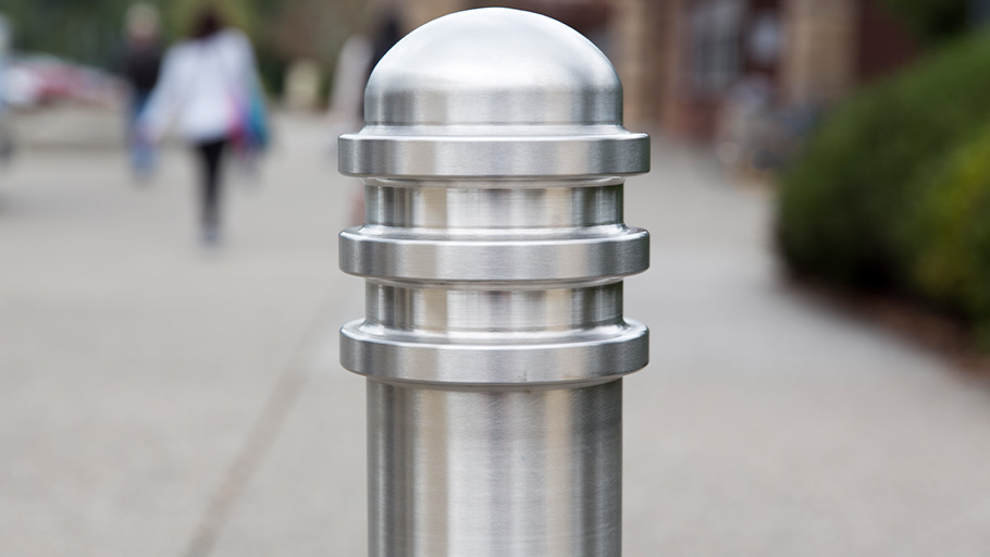 A close-up shot of a Reliance Foundry stainless steel bollard