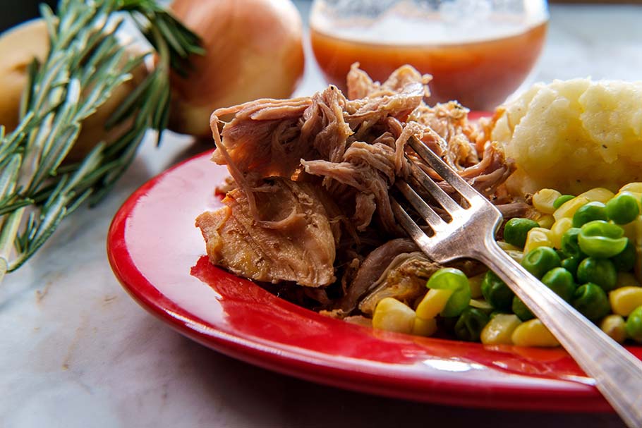 Smoked pulled pork with mashed potatoes and veggies