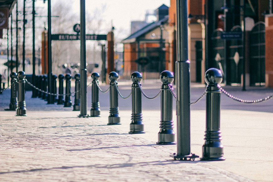 A row of pawn-like black cast iron bollards decorate Camden Yards