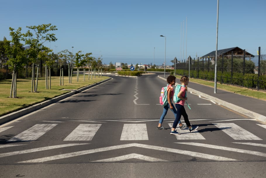 Two girls cross a road