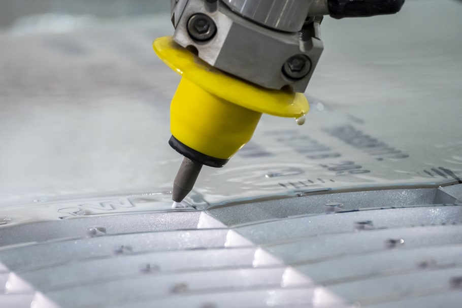 A sheet of aluminum being cut precisely by waterjet