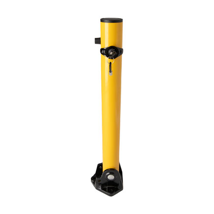 A bright yellow collapsible bollard with black at base, hinges, and locking mechanism