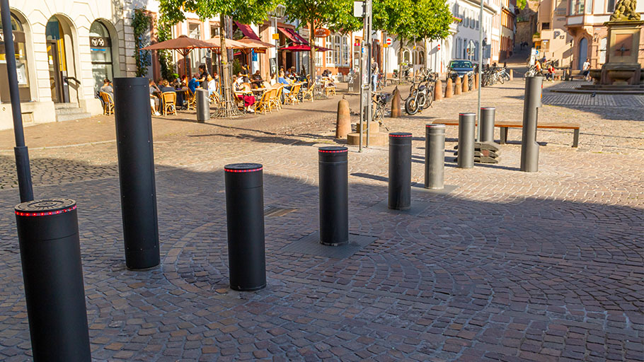 Automatic crash-rated bollards installed in an outdoor shopping mall as a preventive measure against ram-raids.
