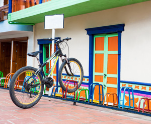 Colorful and decorative bike rack matches a colorful building nearby