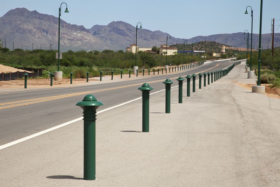 A line of green bollards with interesting tops
