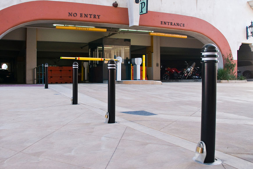 Fabricated bollards placed in a row in front of an underground parking entrance