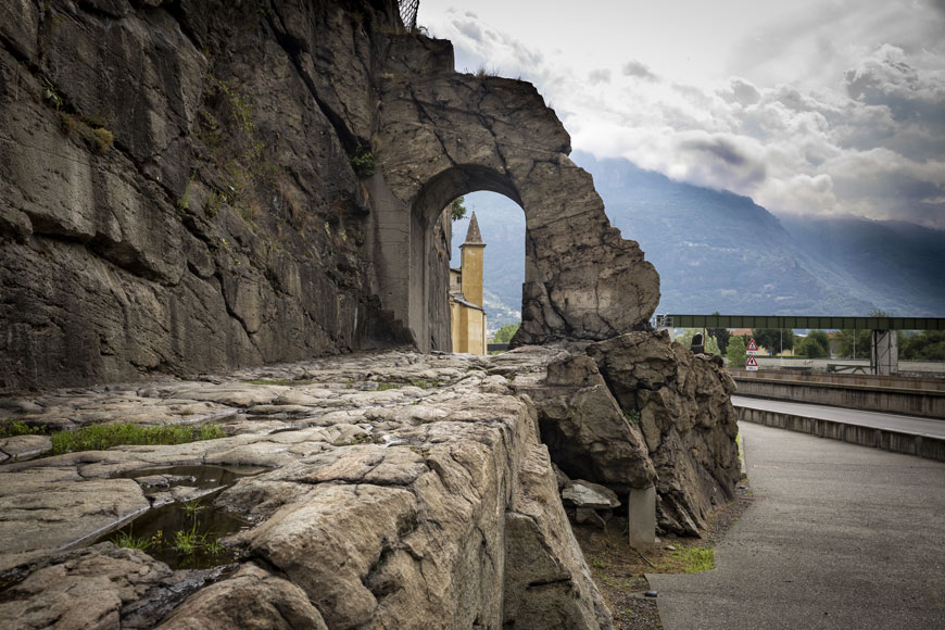 An ancient roman road and arch still stands in the Aosta valley in Italy