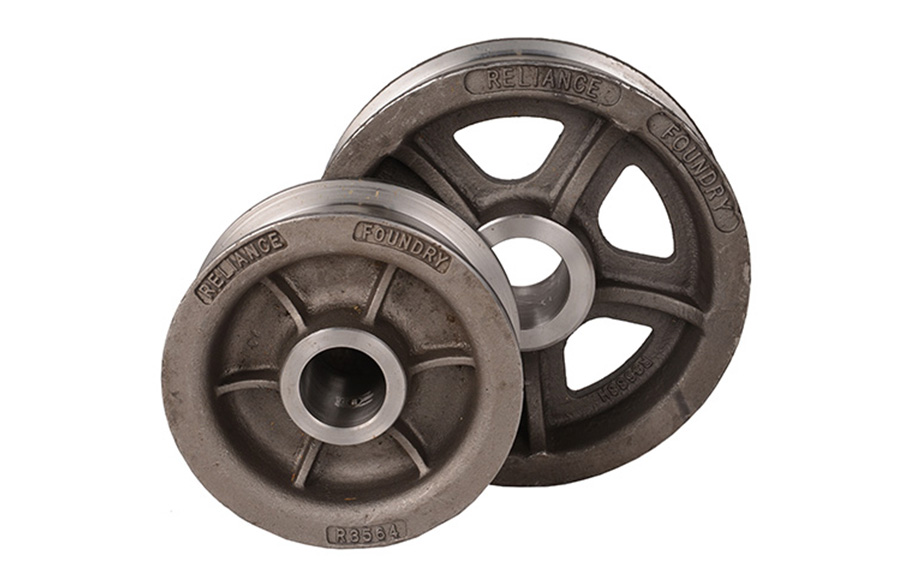Two steel wheels sit on a white background, one smaller and solid, one larger with holes between bracing ribs