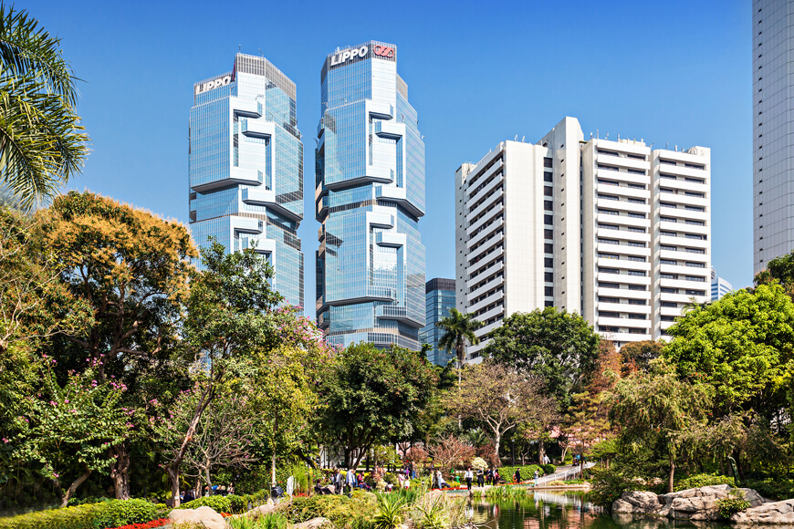An urban park landscape beside a high-rise building, designed with user access