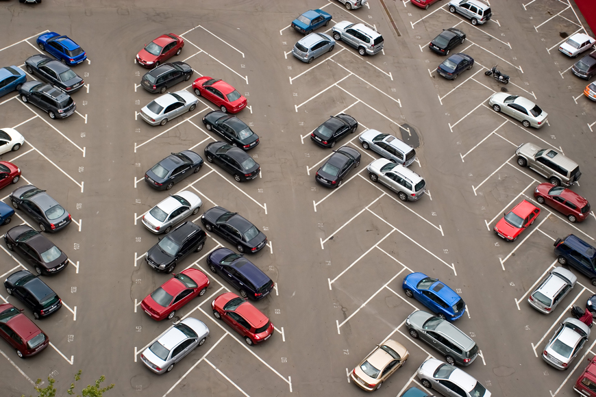 Aerial view of cars parked in a herringbone pattern with drive-in angle stalls and one-way lanes