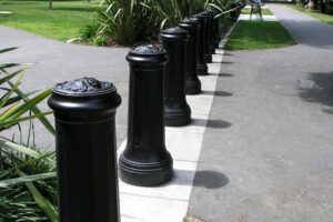 A line of heavy black protective bollards with lion engraved caps guard California’s state capitol