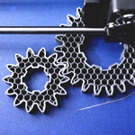A 3D printer creates the prototype for spur gears