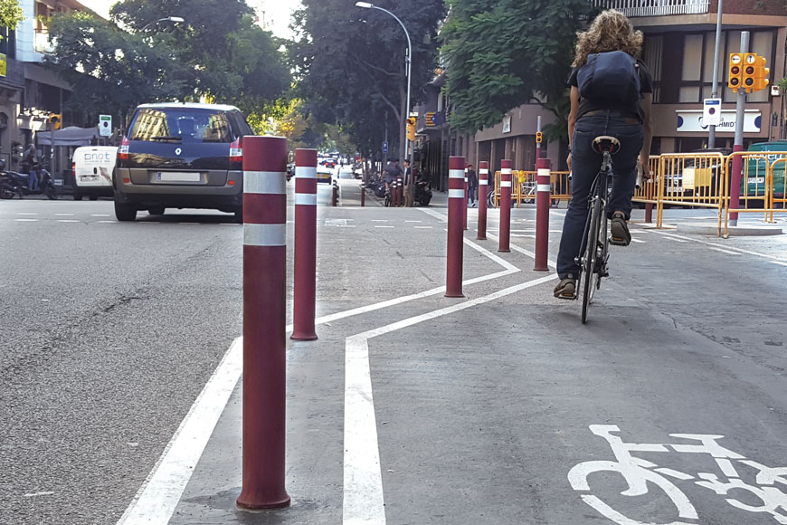 Tough flexible bollards delineate a separated bike lane