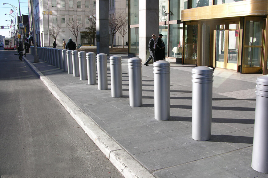 Silver bollards protect city sidewalk in downtown area