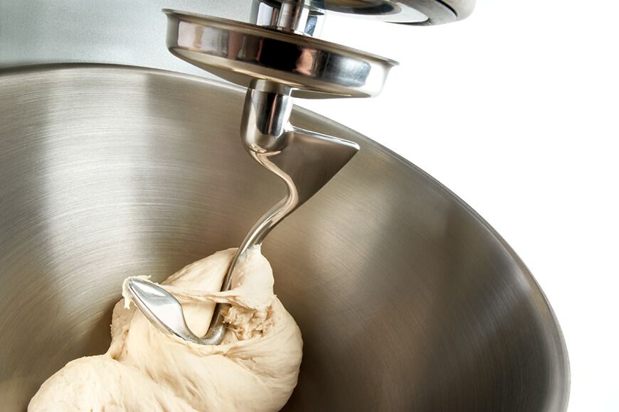 stainless steel stand mixer kneading bread dough