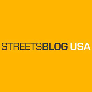 A yellow-backed logo with the name StreetsBlog USA