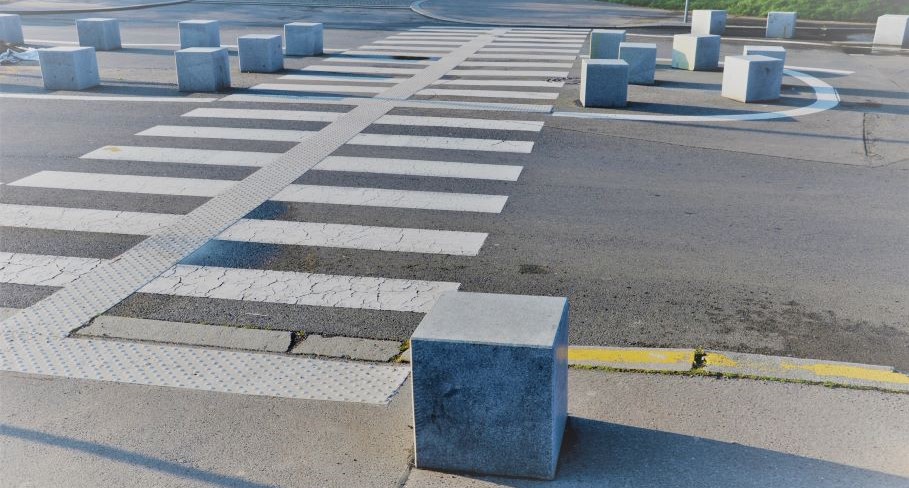 Square blocks as bollards protect an intersection with an H shape pattern of DWPs that cross the street