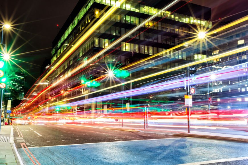 Speeding traffic creates colored lines of light in city street