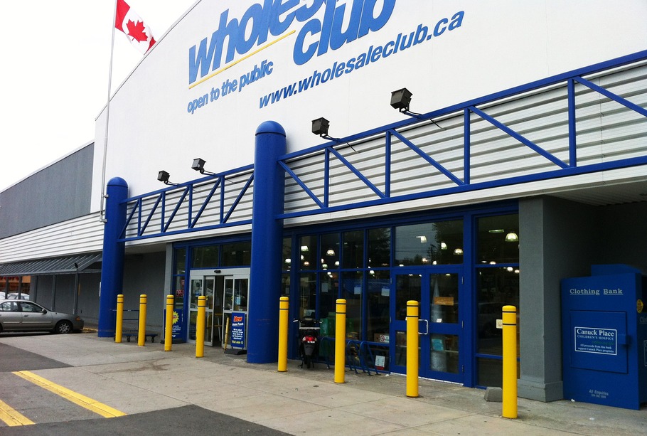Plastic bollard sleeves protecting the front of a Wholesale Club in Canada.