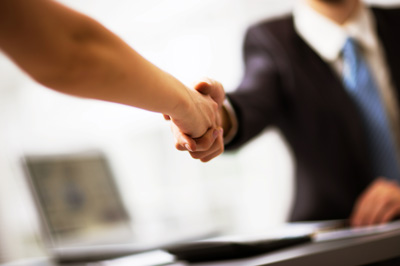 Business people shake hands to seal a deal
