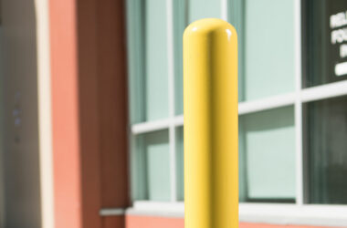 Yellow safety bollard in front of building